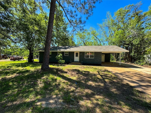view of front of property featuring driveway and an attached carport