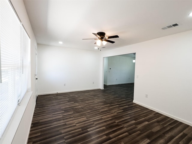 spare room with recessed lighting, dark wood-style flooring, ceiling fan, and visible vents