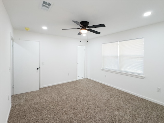 carpeted spare room with baseboards, a ceiling fan, visible vents, and recessed lighting