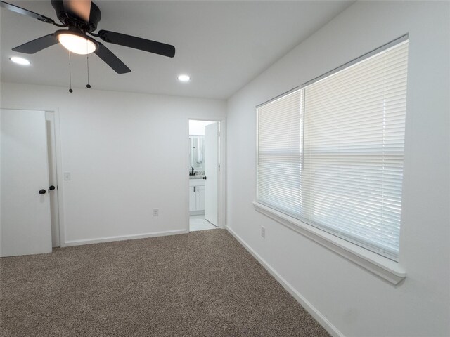 carpeted spare room featuring ceiling fan, baseboards, and recessed lighting