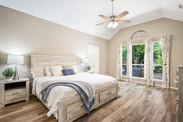 bedroom featuring ceiling fan, vaulted ceiling, wood finished floors, and baseboards