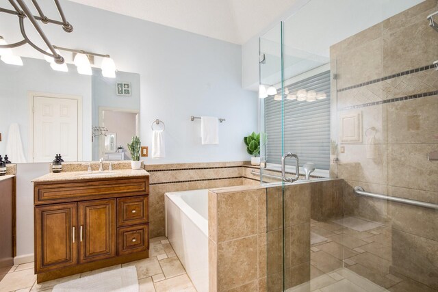 full bath with a shower stall, a garden tub, tile patterned floors, and vanity