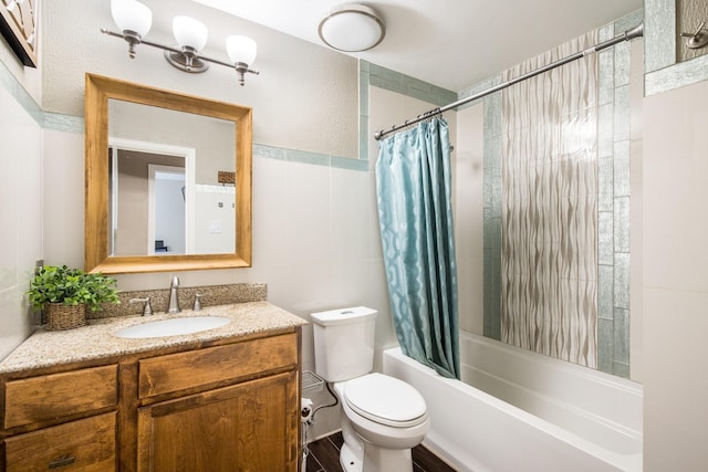 full bath featuring toilet, tile walls, vanity, and shower / bathtub combination with curtain