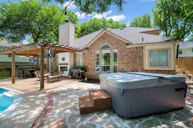 exterior space with fence, a pergola, a shingled roof, a patio area, and a hot tub