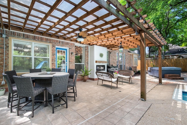 view of patio featuring a pergola, fence, a hot tub, ceiling fan, and outdoor dining area