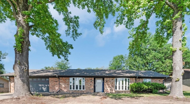 ranch-style home with an attached garage and brick siding