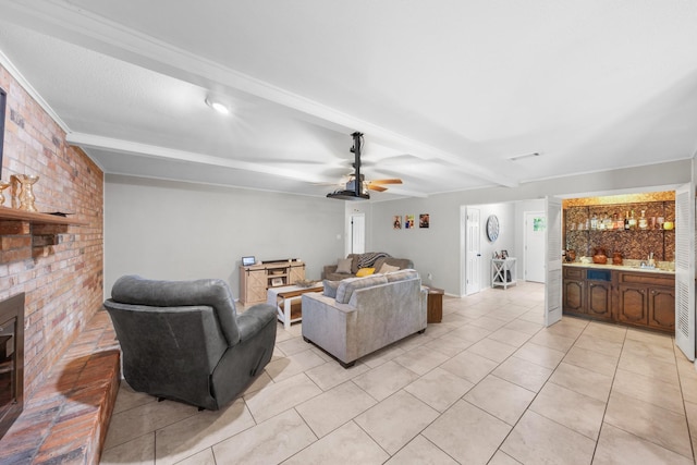 living area with beamed ceiling, brick wall, a ceiling fan, and wet bar