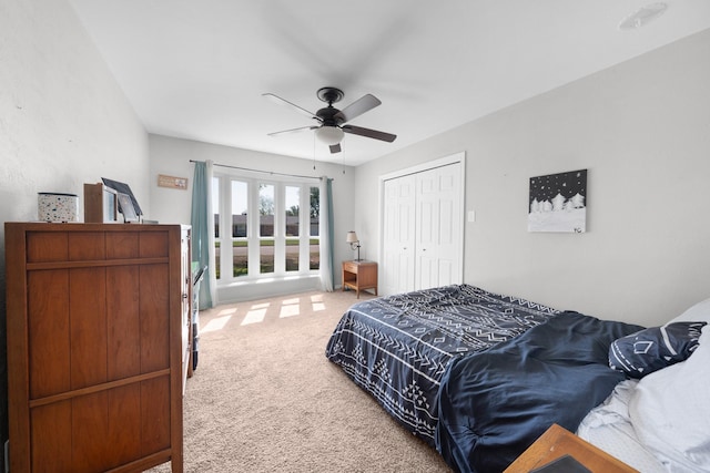 bedroom with a closet, carpet flooring, and a ceiling fan