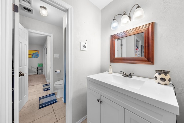 bathroom featuring tile patterned floors, vanity, and toilet
