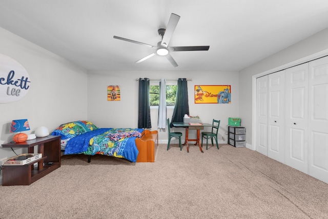 bedroom with a closet, baseboards, a ceiling fan, and carpet