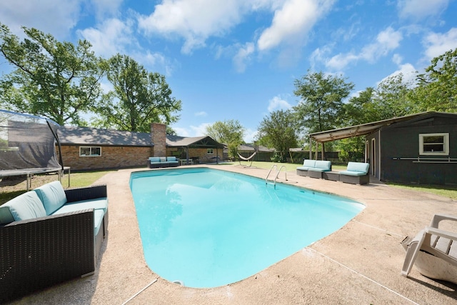 view of pool with a trampoline, an outdoor hangout area, a fenced in pool, and a patio