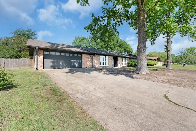 ranch-style home with fence, a front lawn, concrete driveway, brick siding, and a garage
