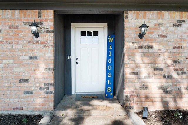 entrance to property with brick siding