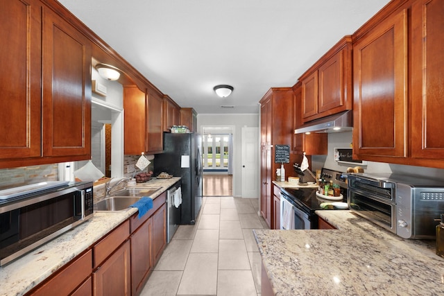 kitchen featuring under cabinet range hood, tasteful backsplash, stainless steel appliances, and a sink