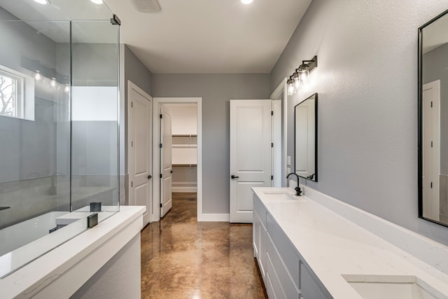 full bathroom with a sink, double vanity, visible vents, baseboards, and finished concrete floors