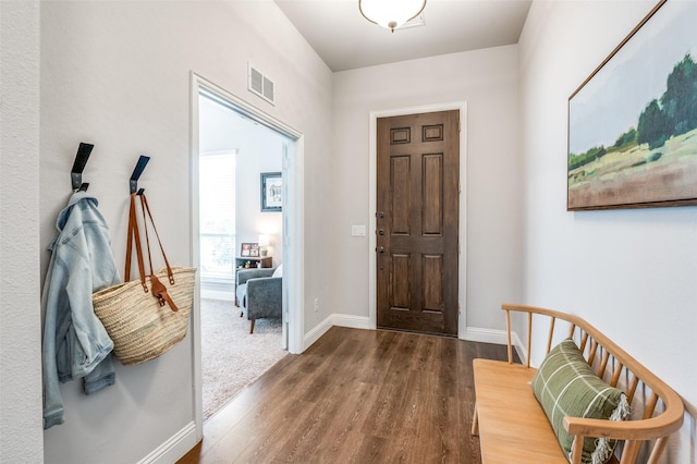 entryway featuring baseboards, visible vents, and dark wood finished floors