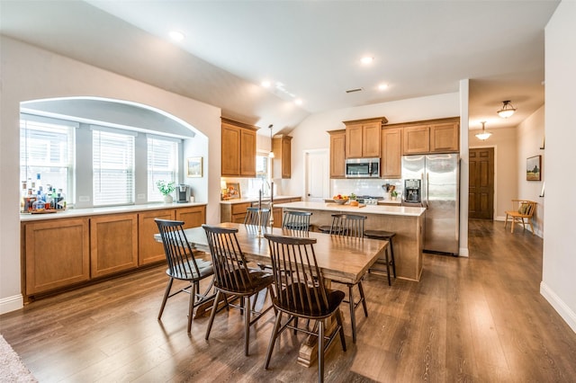 dining area with baseboards, lofted ceiling, and dark wood-style floors