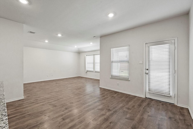 empty room with baseboards, visible vents, recessed lighting, and dark wood-type flooring