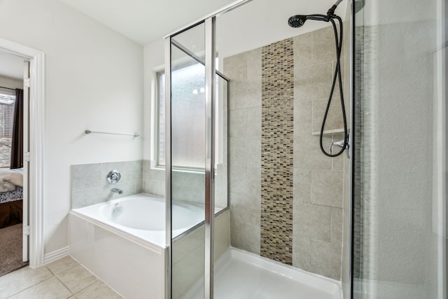 ensuite bathroom featuring a garden tub, ensuite bath, tile patterned flooring, and a shower stall