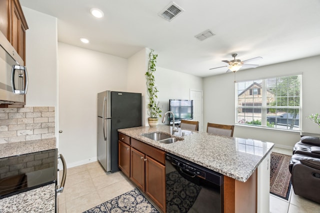 kitchen with open floor plan, visible vents, a sink, and black appliances