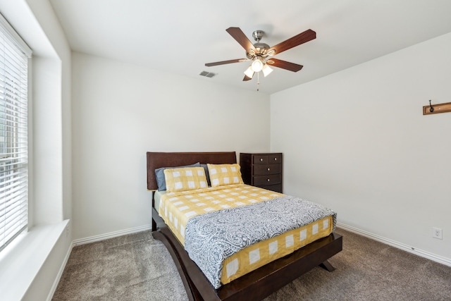 bedroom with carpet floors, a ceiling fan, visible vents, and baseboards
