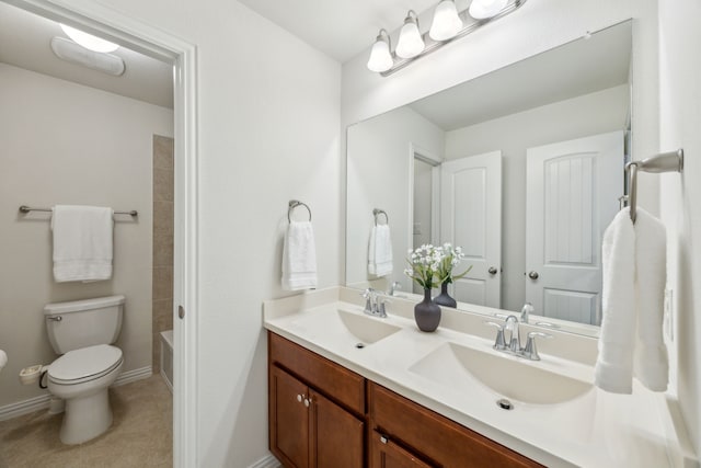 bathroom with tile patterned flooring, a sink, double vanity, and toilet