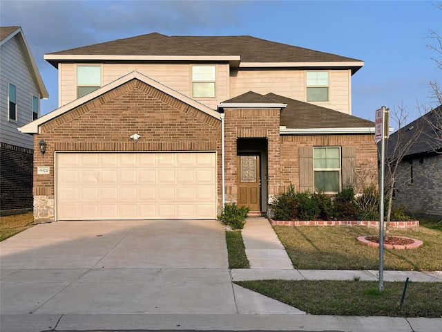 traditional home with a shingled roof, a front lawn, driveway, and brick siding
