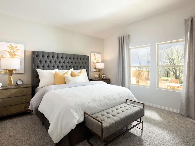 carpeted bedroom featuring vaulted ceiling and baseboards