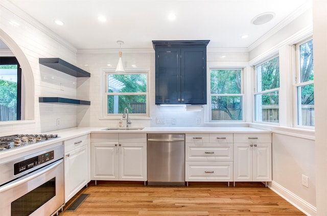 kitchen with stainless steel appliances, open shelves, decorative backsplash, and a sink