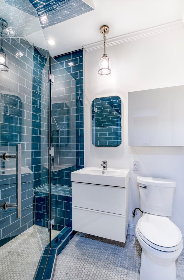 bathroom featuring crown molding, tile patterned flooring, a shower stall, vanity, and toilet