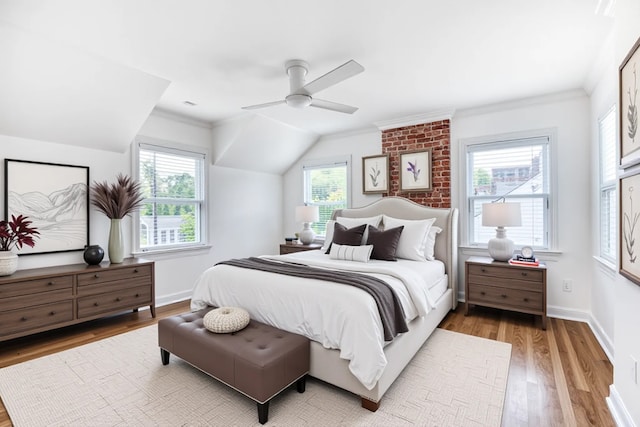 bedroom featuring light wood-style floors, multiple windows, and ceiling fan