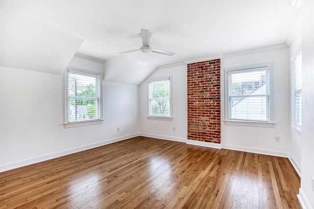 additional living space with baseboards, a ceiling fan, lofted ceiling, and wood finished floors