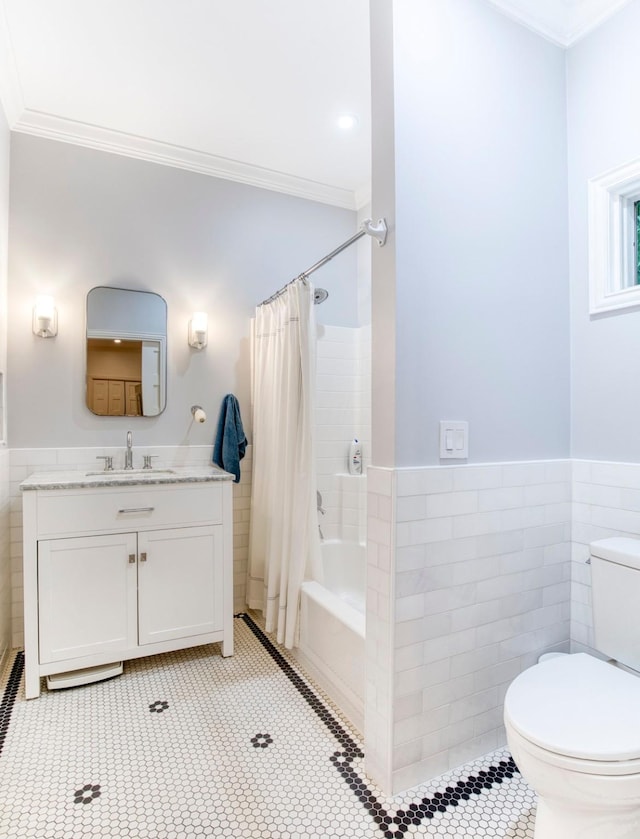 bathroom with tile walls, tile patterned flooring, vanity, toilet, and ornamental molding