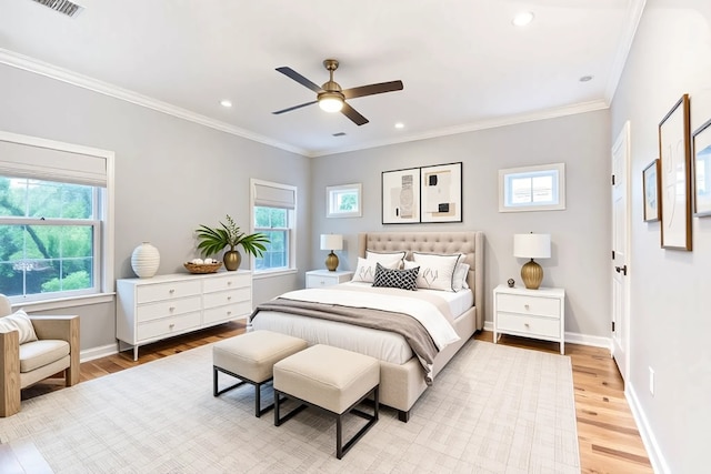bedroom featuring baseboards, light wood-style flooring, and multiple windows