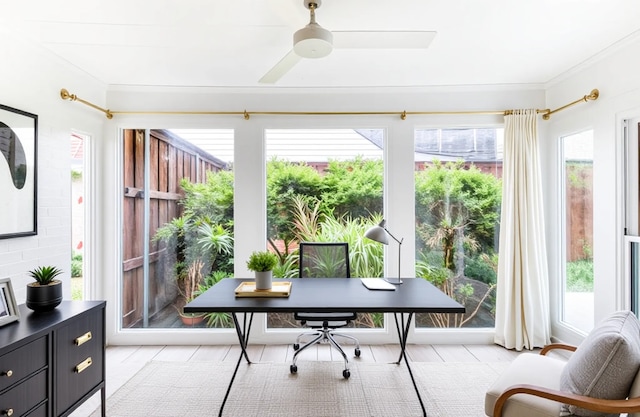 office space with crown molding, plenty of natural light, and ceiling fan