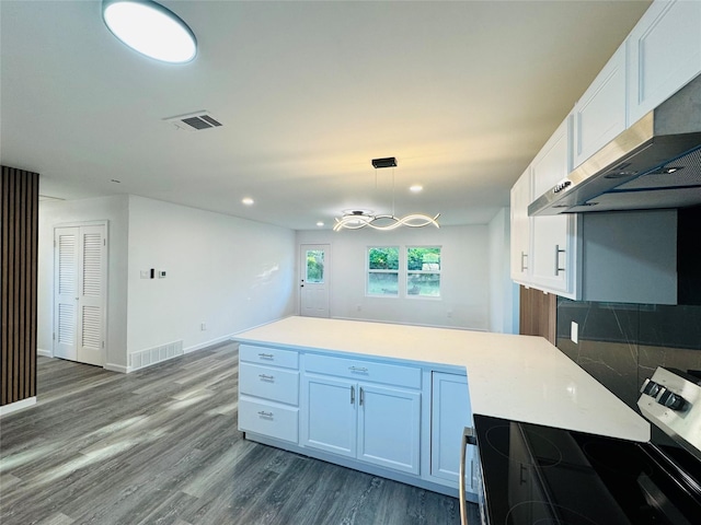 kitchen with white cabinets, stainless steel electric stove, under cabinet range hood, and visible vents