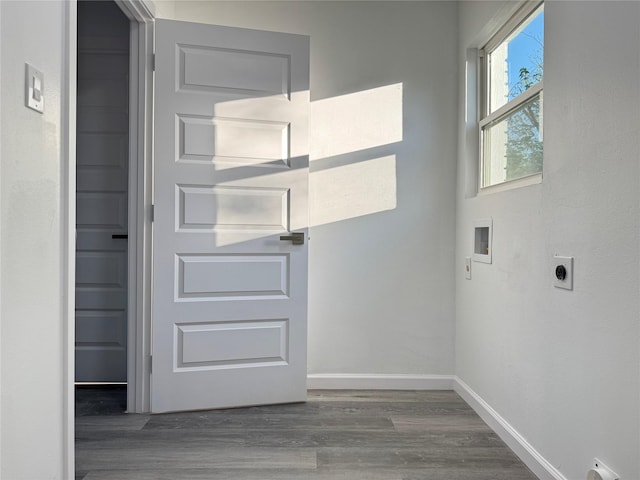 clothes washing area with laundry area, wood finished floors, hookup for an electric dryer, hookup for a washing machine, and baseboards