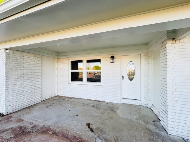 property entrance with brick siding