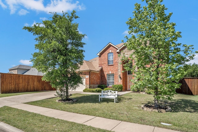 3059 Seabrook Dr, Little Elm, TX 75068 - traditional-style house with fence, a front yard, brick siding, concrete driveway, and an attached garage