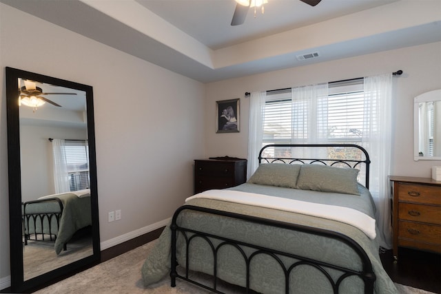 bedroom with baseboards, visible vents, ceiling fan, and multiple windows