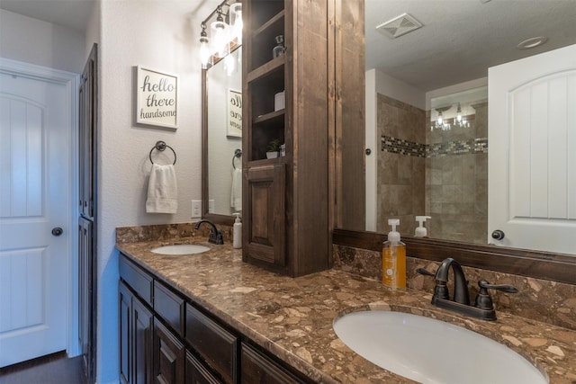 full bathroom featuring a sink, visible vents, and double vanity