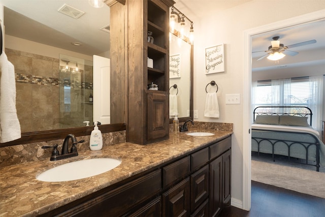 ensuite bathroom with double vanity, visible vents, a sink, and ceiling fan