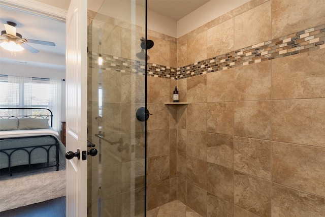 full bath with connected bathroom, a tile shower, and a ceiling fan