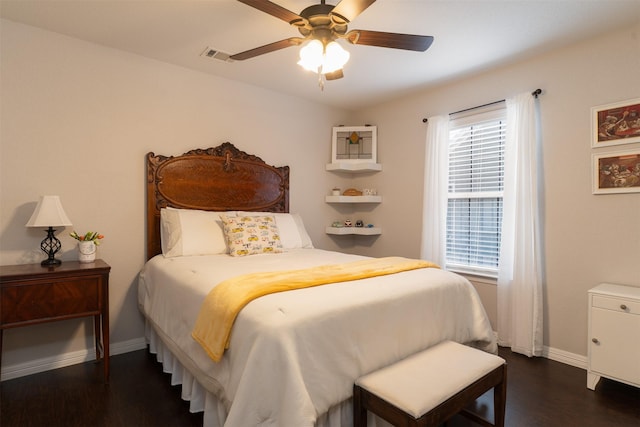 bedroom featuring visible vents, a ceiling fan, baseboards, and dark wood-style flooring