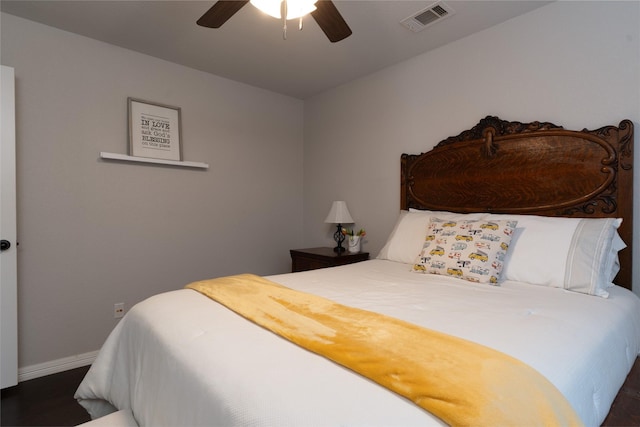 bedroom with wood finished floors, visible vents, ceiling fan, and baseboards