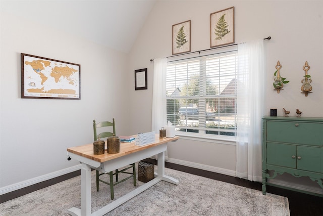 home office featuring lofted ceiling and baseboards