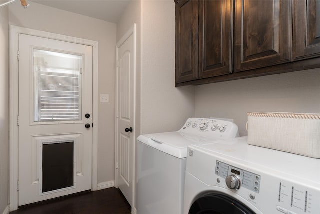 laundry room featuring cabinet space, baseboards, and washer and clothes dryer