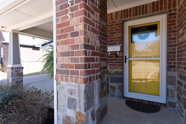 entrance to property with brick siding