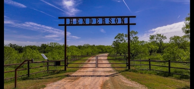 view of road with a gate and a forest view