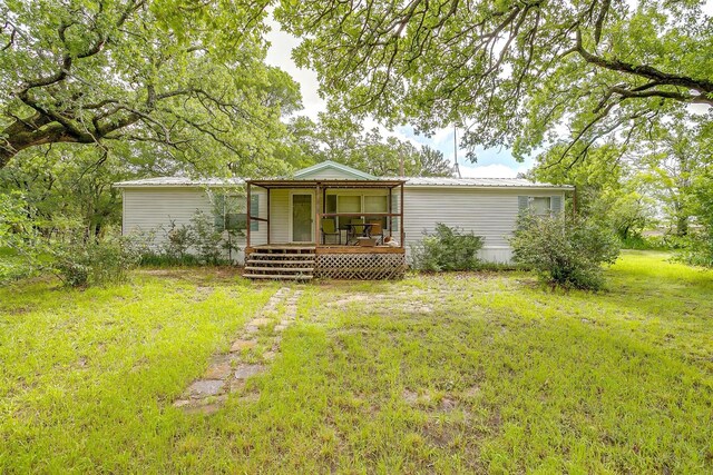 7203 Pump Station Rd, Jacksboro, TX 76458 - rear view of house with a porch, a lawn, and metal roof